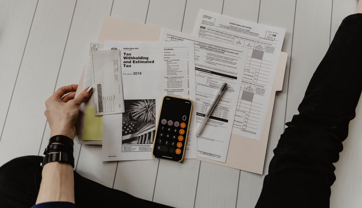 Tax paperwork and calculator on a desk